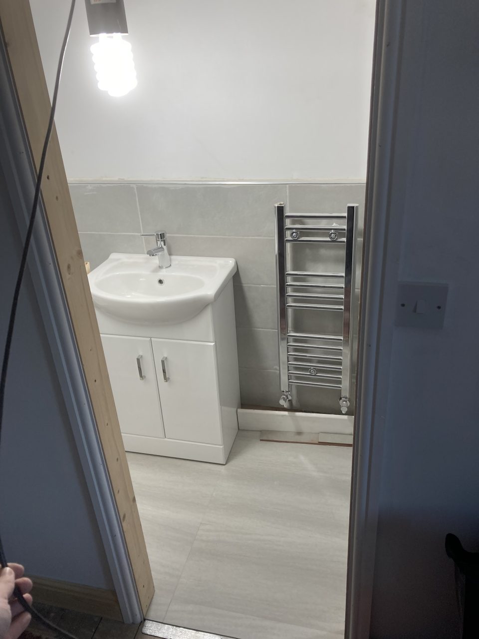 The finished en-suite — WC and basin in the compact new shower room.