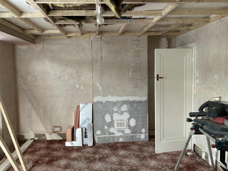 Strip-out: the ceiling taken back to the joists and the walls stripped, ready to re-board and plaster.