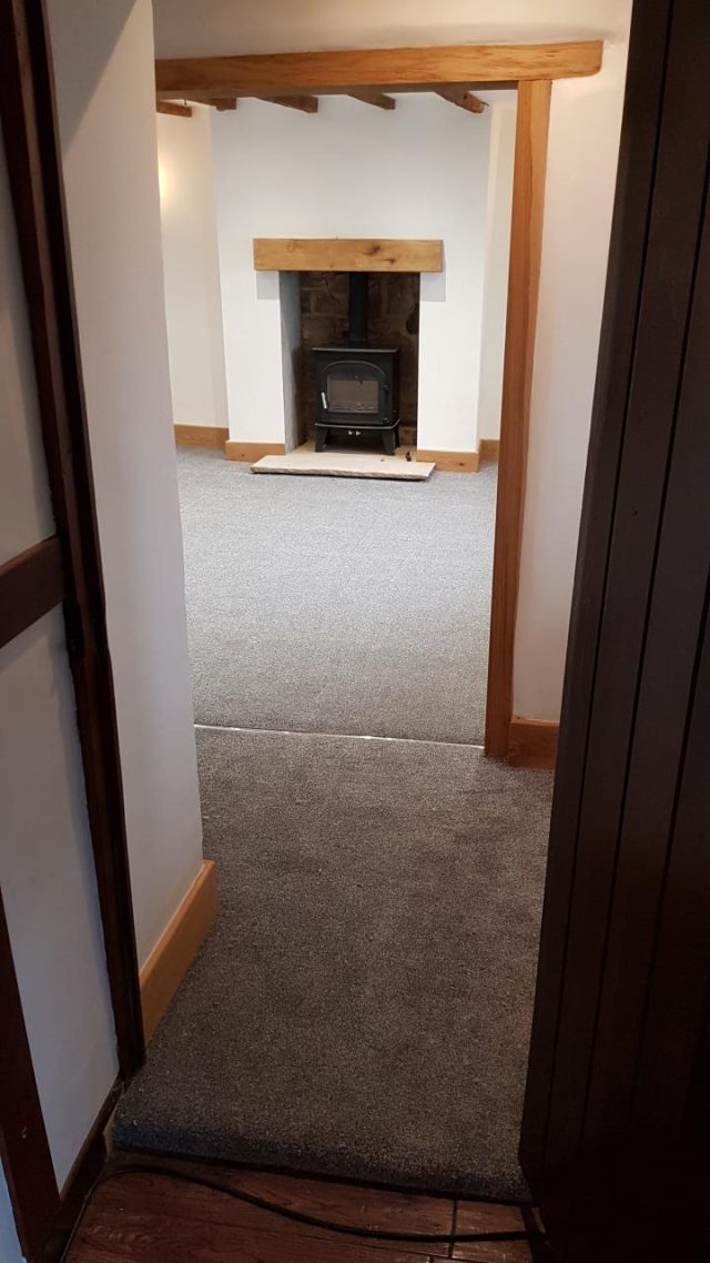 Fitting: the renovated room taking shape, seen through the new oak-lined doorway.