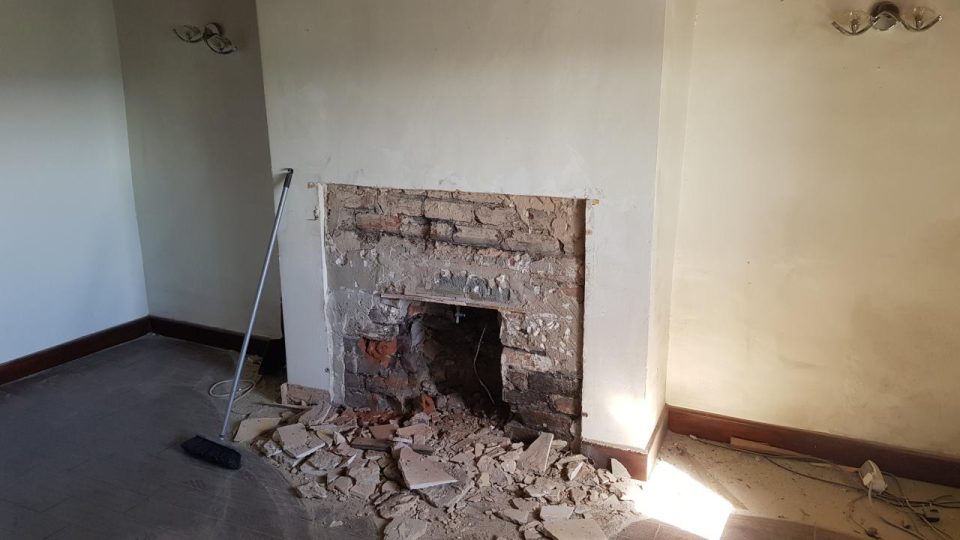 Strip-out: the blocked fireplace opened back up to reveal the original stone surround.
