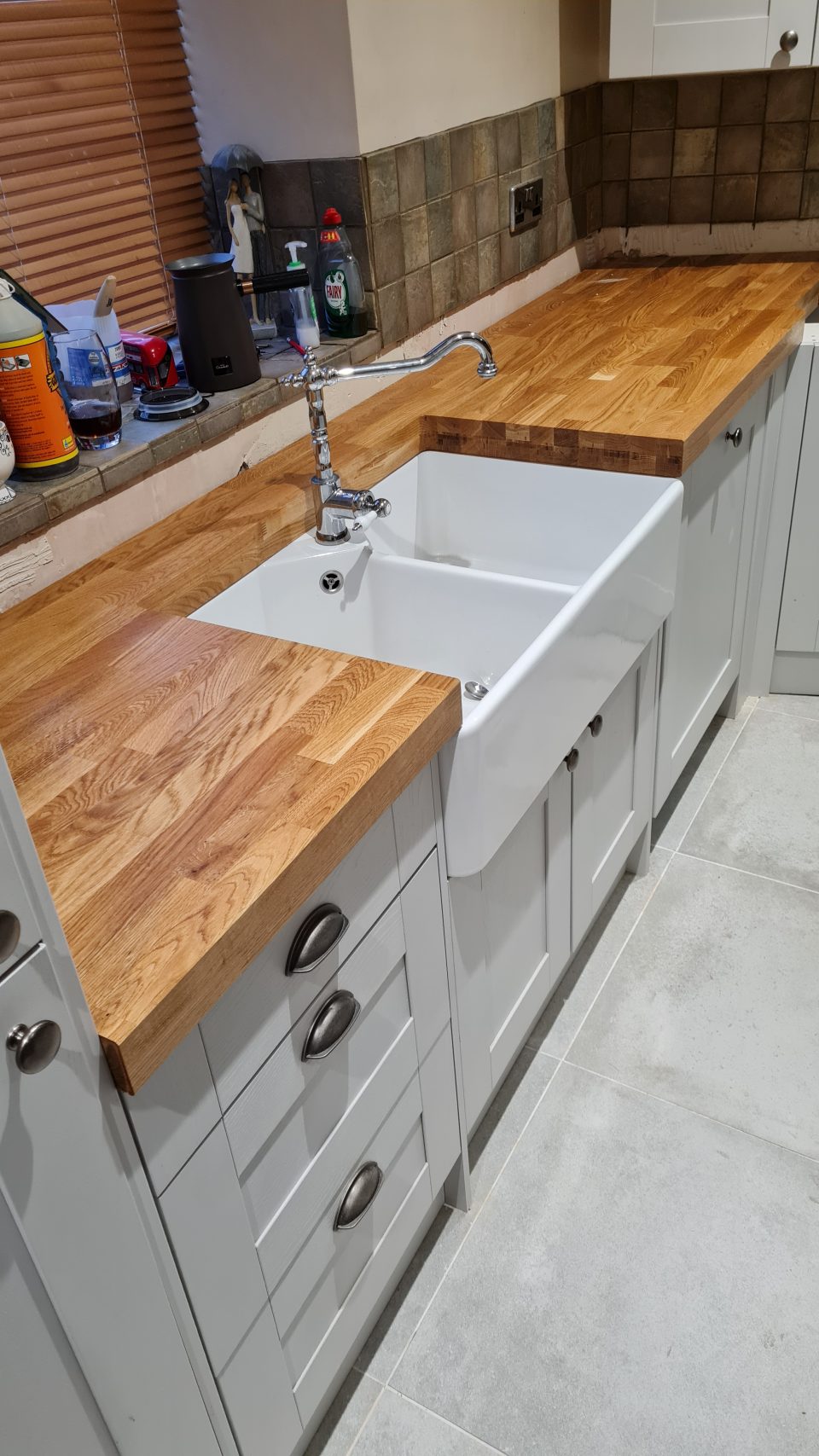 The refit underway — new base units going in and a solid oak worktop being fitted.